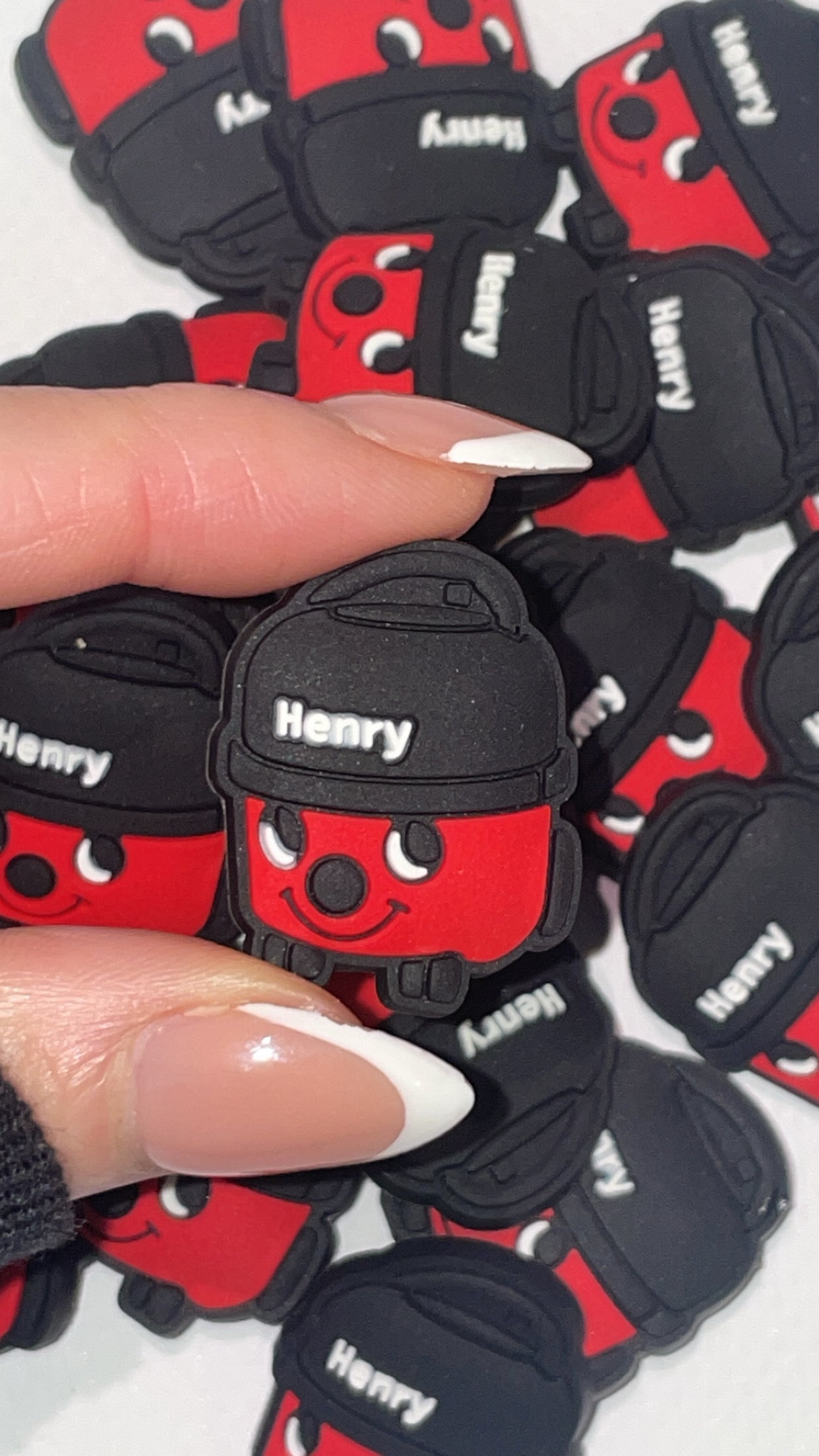 Cute red vacuum-inspired Croc charms set with smiling designs”
“Cleaning-themed Croc charms on black and red Crocs shoes”
“Vacuum and smiley Croc charms flat lay – fun home-themed designs”
“Red vacuum Croc charms gift set – inspired by classic British designs”
“Cute hoover-style Croc charms for cleaners and retro fans”