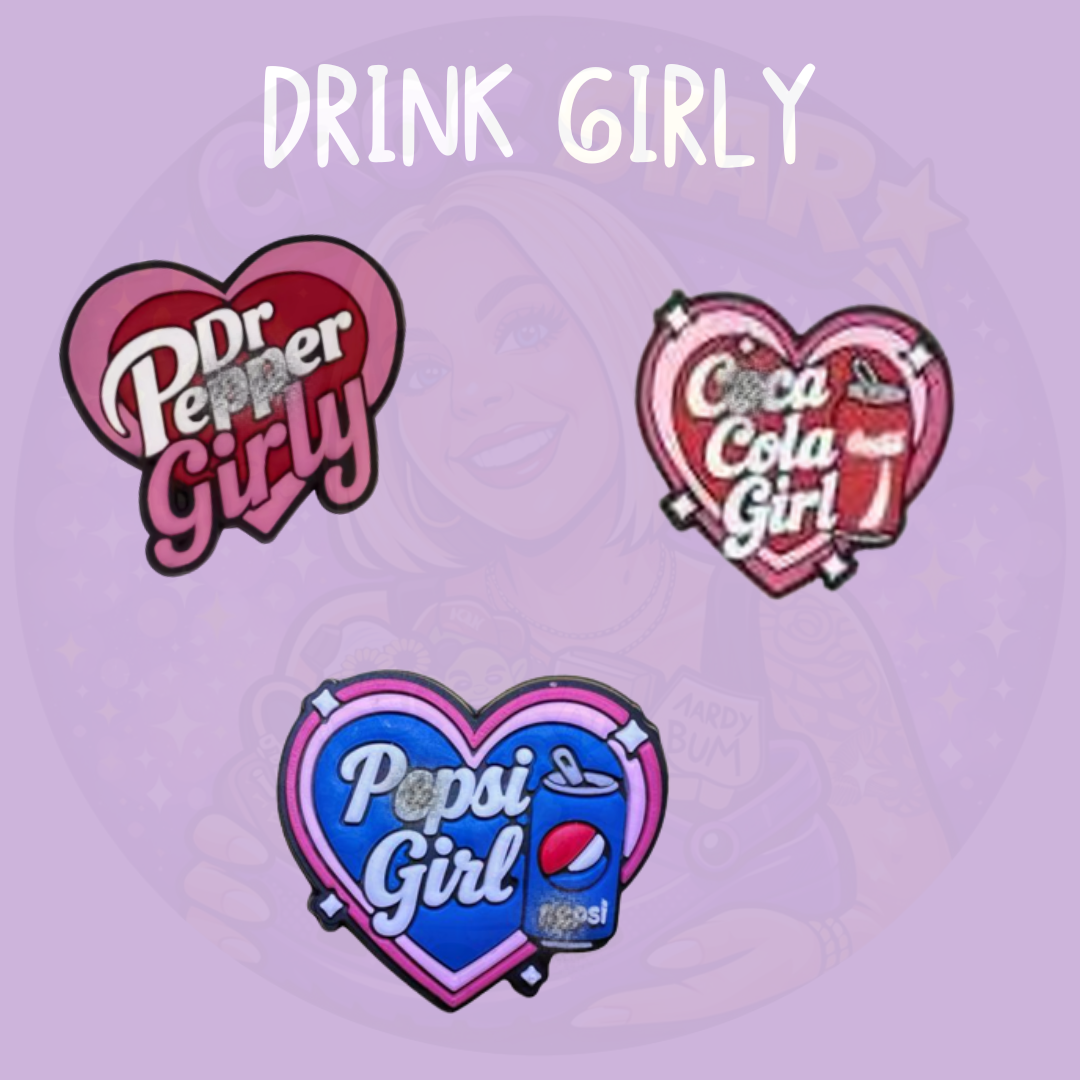 Set of three soda inspired croc charms with heart shaped designs in pink and blue featuring drink themed graphics on a purple background
