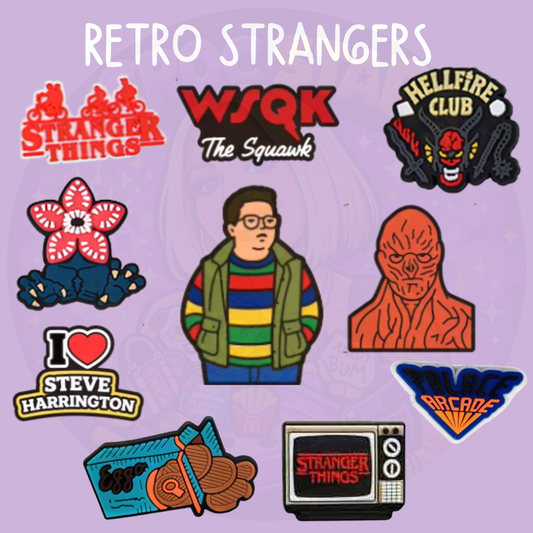 Set of retro 80s mystery inspired croc charms featuring arcade, creature, and vintage TV style designs on a purple background