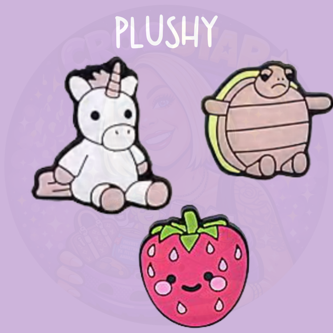 Cute plush style croc charms featuring a unicorn, turtle and strawberry design on a purple background