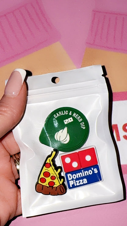 Pizza themed croc charms featuring a cheesy slice, dipping sauce and takeaway style design on a purple background