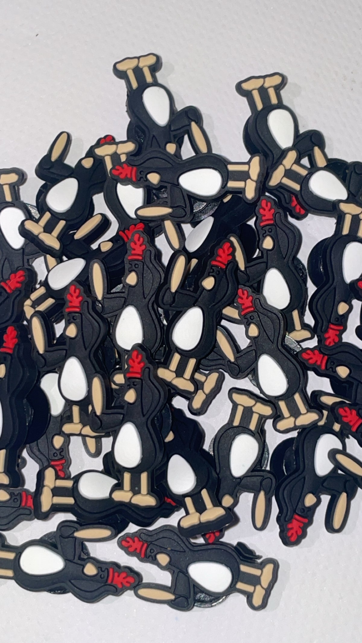 Sneaky penguin Croc charm featuring a black and white cartoon penguin design
