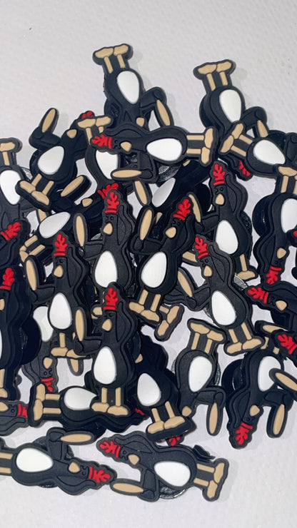 Sneaky penguin Croc charm featuring a black and white cartoon penguin design