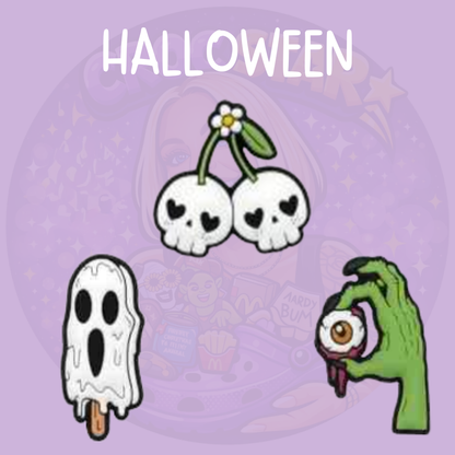 Halloween Croc charms featuring skull cherries, a spooky ghost ice lolly and zombie hand holding an eyeball