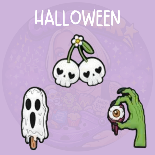 Halloween Croc charms featuring skull cherries, a spooky ghost ice lolly and zombie hand holding an eyeball