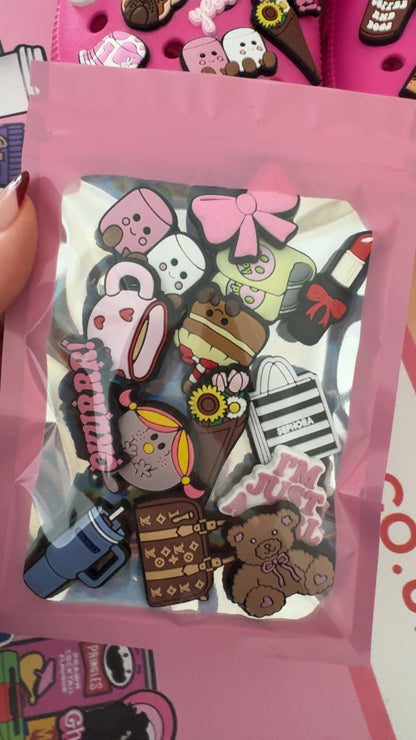 Cute pink and girly shoe charms featuring bows, lipstick, coffee, flowers, teddy bears and accessories.