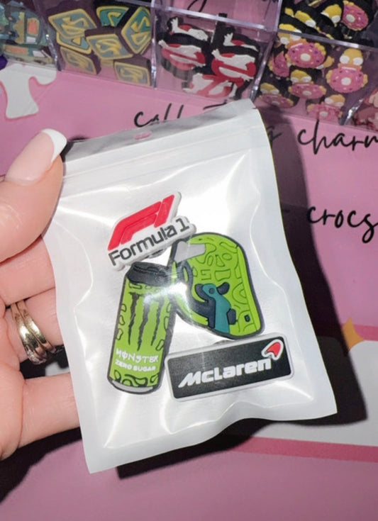 Racing inspired croc charm bundle with green helmet, energy drink style charm and motorsport logo charms in packaging