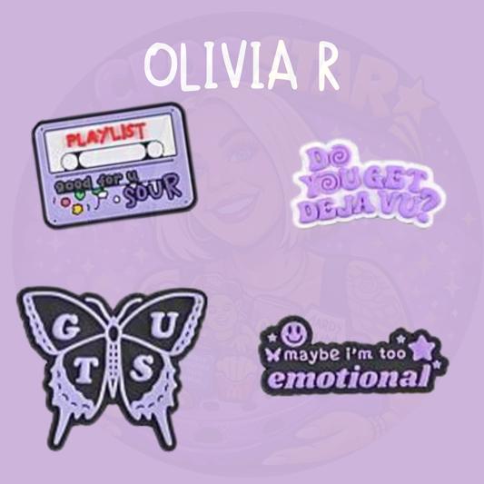 Music inspired croc charms featuring playlist design, lyric style text and butterfly aesthetic on a purple background